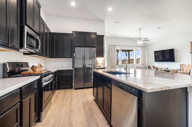 kitchen featuring a ceiling fan, a center island with sink, visible vents, a sink, and appliances with stainless steel finishes