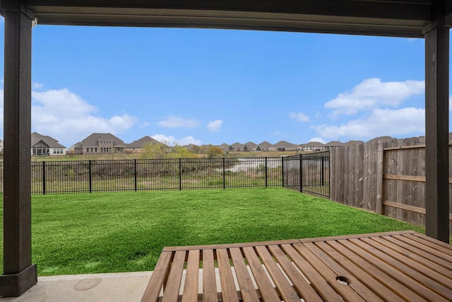 view of yard with a fenced backyard and a residential view