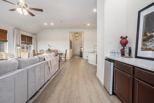 living area with a ceiling fan, baseboards, lofted ceiling, recessed lighting, and light wood-style floors