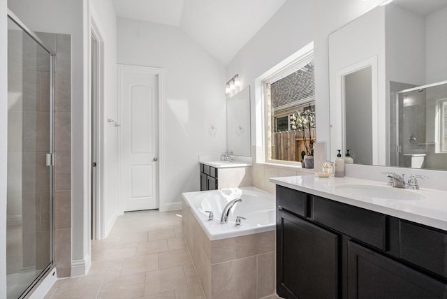 full bathroom featuring tile patterned floors, a garden tub, a sink, a shower stall, and vaulted ceiling