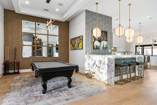 rec room featuring pool table, a raised ceiling, light wood-style floors, and visible vents