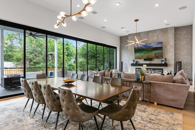 dining space with a chandelier, visible vents, and a wealth of natural light