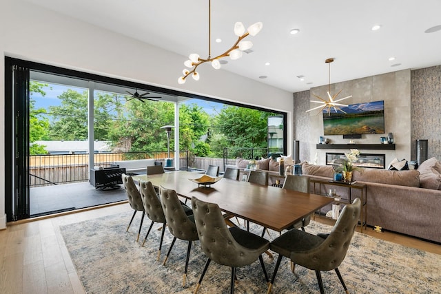 dining space featuring recessed lighting, a notable chandelier, and hardwood / wood-style floors