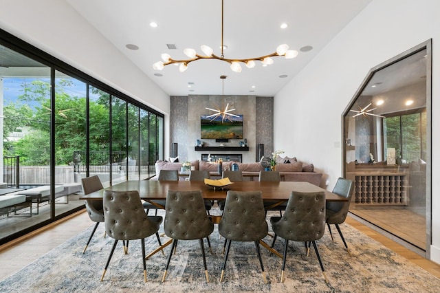 dining area featuring visible vents, an accent wall, a chandelier, recessed lighting, and wood finished floors