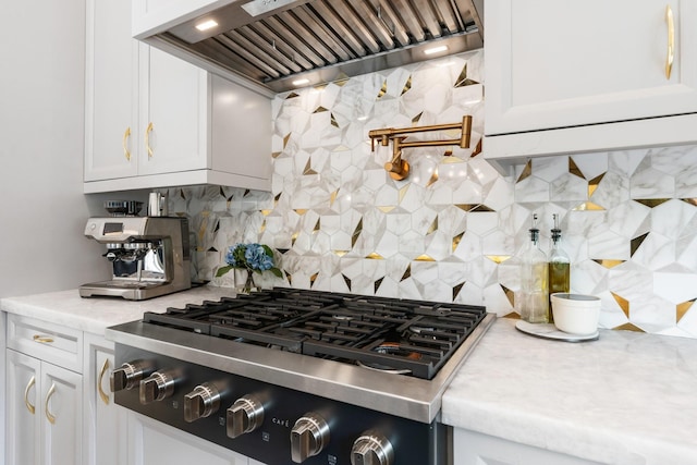 kitchen with decorative backsplash, custom exhaust hood, white cabinets, and gas stovetop