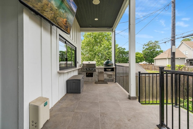 view of patio / terrace featuring area for grilling, exterior kitchen, and fence