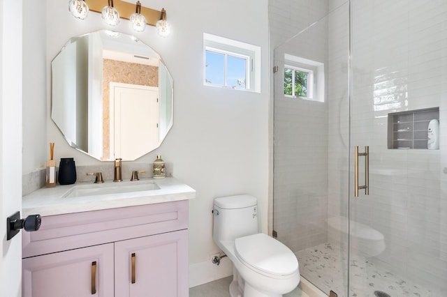 bathroom featuring vanity, toilet, and a shower stall