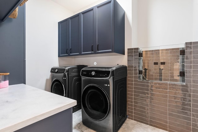 washroom with cabinet space and independent washer and dryer