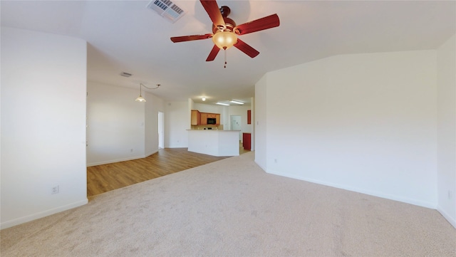 unfurnished living room with baseboards, ceiling fan, visible vents, and light carpet
