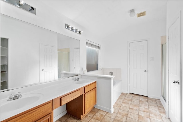 full bathroom featuring a closet, a shower stall, double vanity, a sink, and a garden tub