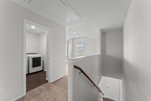 hallway featuring an upstairs landing, washer and dryer, carpet floors, baseboards, and attic access