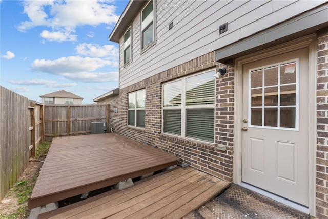 wooden deck featuring cooling unit and fence