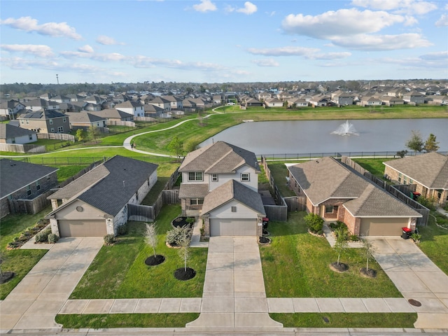 drone / aerial view with a residential view and a water view