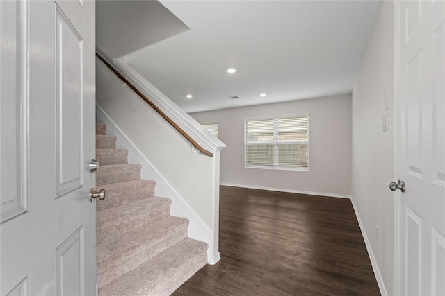 staircase featuring recessed lighting, visible vents, baseboards, and wood finished floors