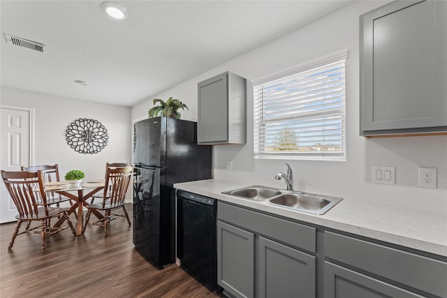 kitchen featuring visible vents, light countertops, gray cabinets, black appliances, and a sink