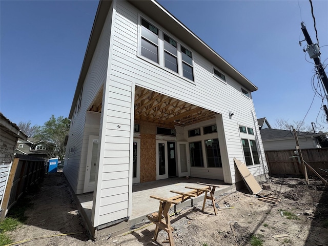 back of house with a fenced backyard and a patio area