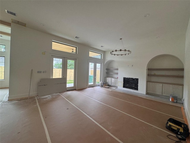 710 E 18th St, Houston, TX 77008 - unfurnished living room featuring a fireplace, french doors, arched walkways, and baseboards