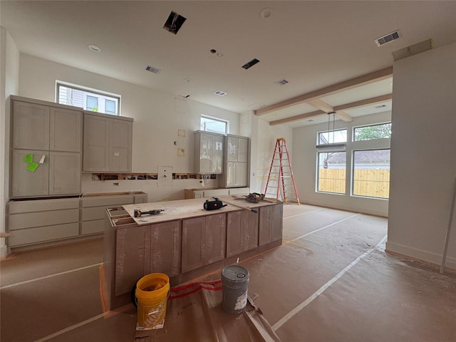 710 E 18th St, Houston, TX 77008 - kitchen featuring plenty of natural light, a kitchen island, and baseboards