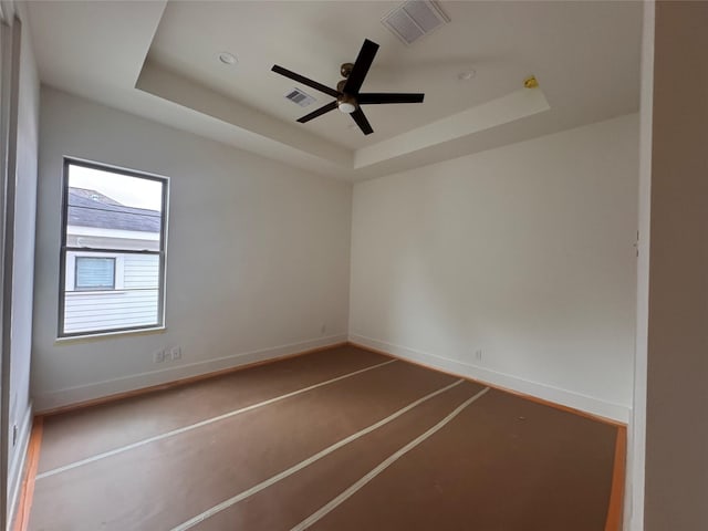 710 E 18th St, Houston, TX 77008 - unfurnished room featuring a raised ceiling, a ceiling fan, and baseboards