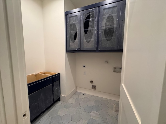 710 E 18th St, Houston, TX 77008 - washroom with electric dryer hookup, cabinet space, light tile patterned floors, and baseboards