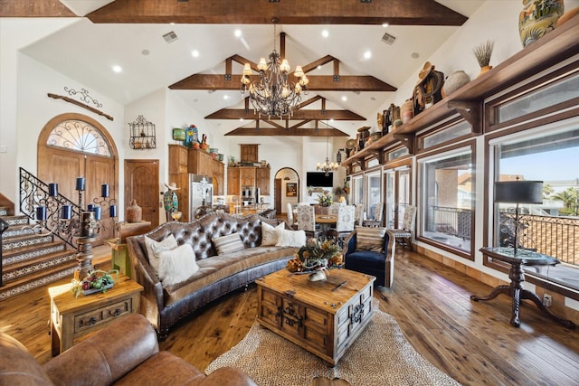 living area featuring visible vents, high vaulted ceiling, a chandelier, and hardwood / wood-style flooring