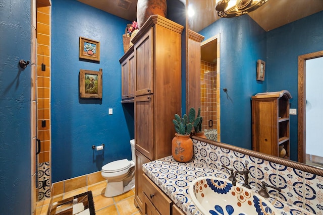full bathroom featuring toilet, tile patterned flooring, and vanity