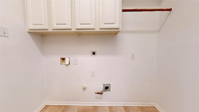 washroom featuring washer hookup, gas dryer hookup, cabinet space, baseboards, and hookup for an electric dryer