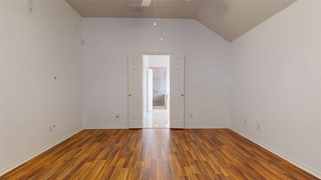 unfurnished room with baseboards, lofted ceiling, a ceiling fan, and wood finished floors