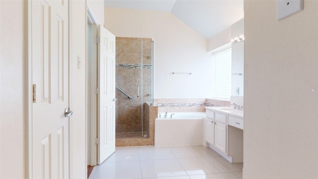 full bathroom featuring vanity, lofted ceiling, a stall shower, a garden tub, and tile patterned floors