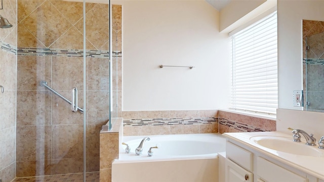 full bath with vanity, a shower stall, a garden tub, and plenty of natural light