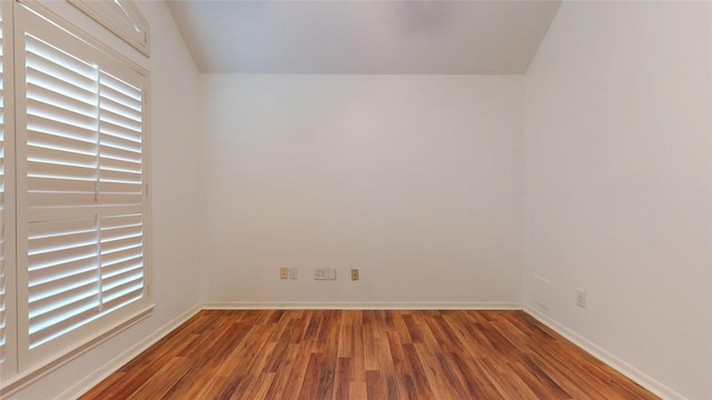 empty room featuring wood finished floors and baseboards