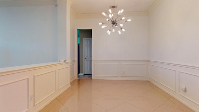 empty room with light tile patterned floors, visible vents, crown molding, a decorative wall, and a chandelier