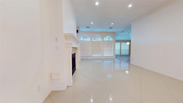 unfurnished room featuring recessed lighting, baseboards, light tile patterned flooring, and a fireplace