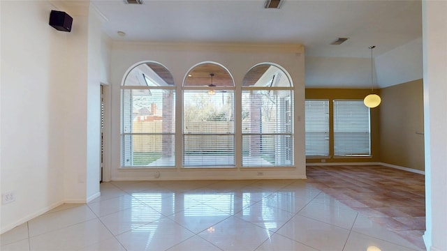 tiled spare room with visible vents and baseboards