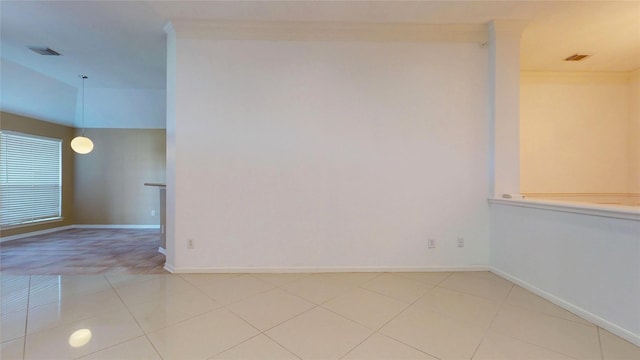 unfurnished room with light tile patterned floors, visible vents, and baseboards