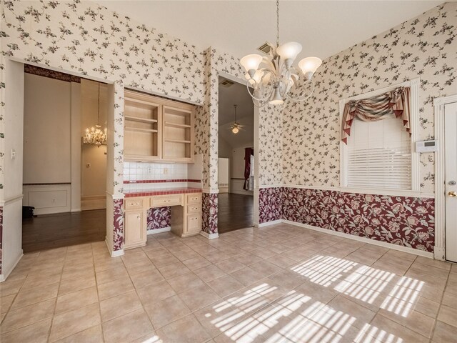spare room with a wainscoted wall, light tile patterned flooring, and wallpapered walls