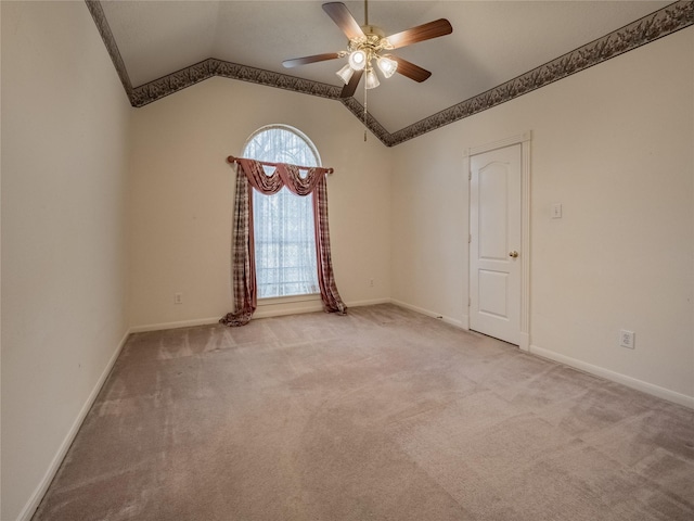 unfurnished room featuring a ceiling fan, baseboards, vaulted ceiling, and carpet