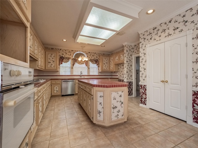 2402 Duhon Pl, Seabrook, TX 77586 - kitchen with oven, wallpapered walls, stainless steel dishwasher, ornamental molding, and a chandelier