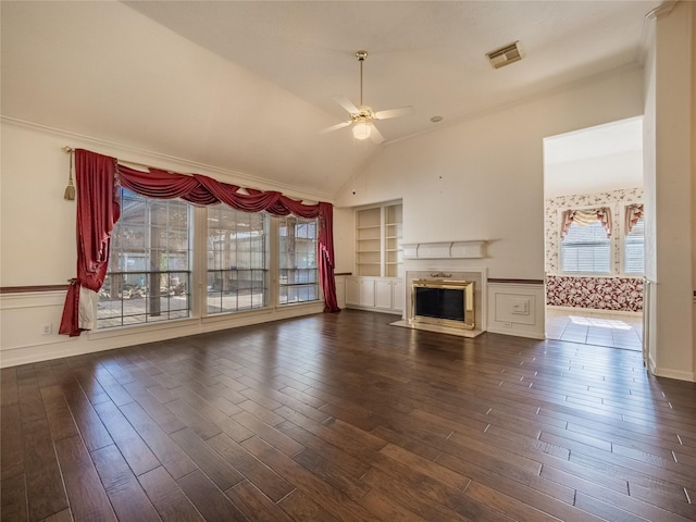 unfurnished living room with dark wood-style flooring, ceiling fan, a fireplace, built in features, and visible vents