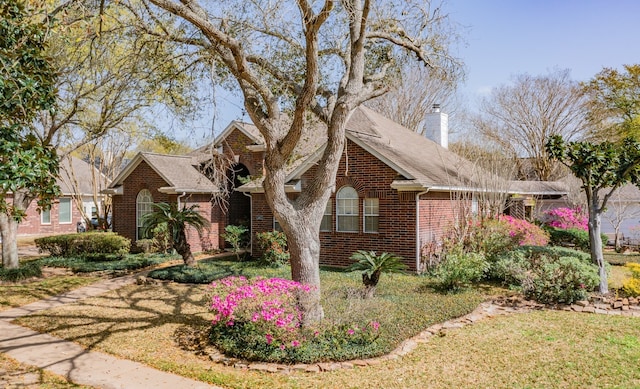 2402 Duhon Pl, Seabrook, TX 77586 - view of front of house featuring brick siding, a chimney, and a shingled roof