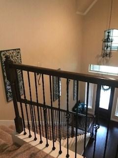stairs featuring a high ceiling, carpet flooring, baseboards, and plenty of natural light