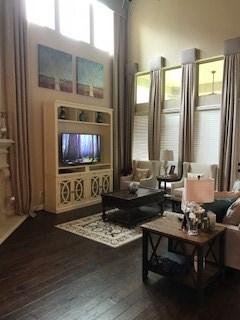 sitting room with dark wood-type flooring