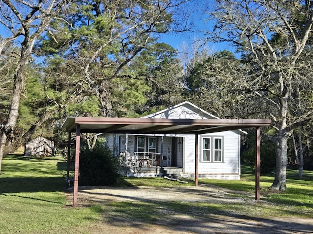 view of front of property with a porch, a carport, and a front lawn