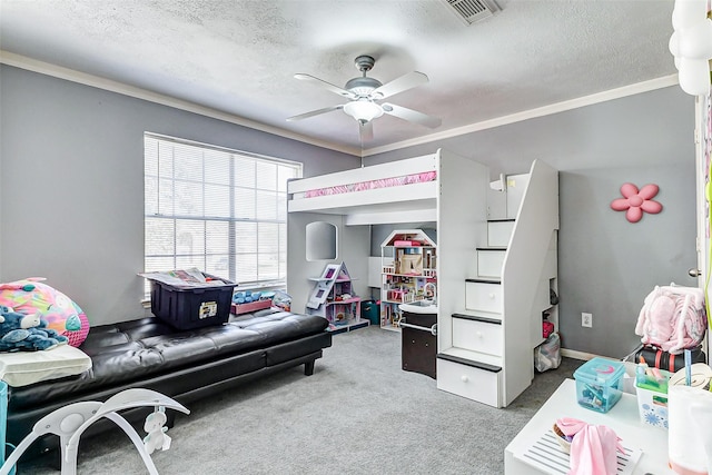 carpeted bedroom featuring visible vents, a textured ceiling, a ceiling fan, and ornamental molding