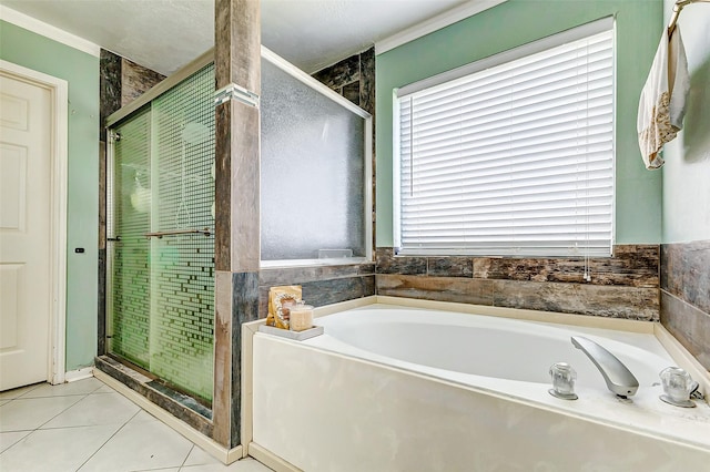 full bathroom featuring tile patterned flooring, a bath, and a stall shower