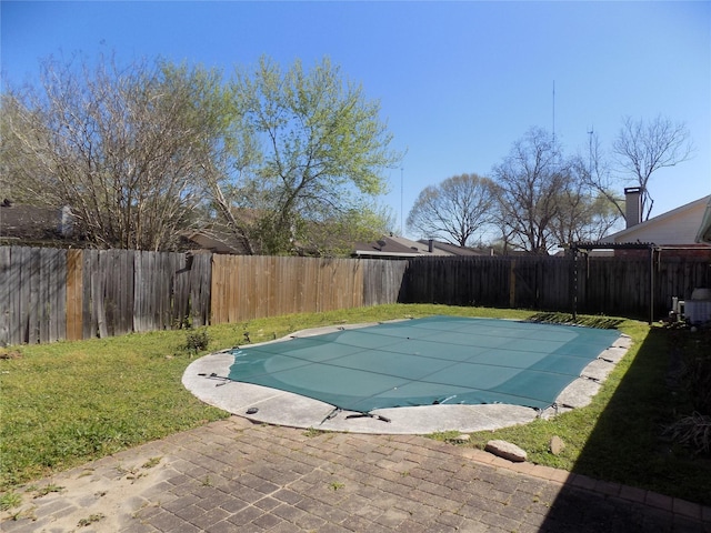 view of swimming pool with a fenced in pool, a patio, a yard, and a fenced backyard