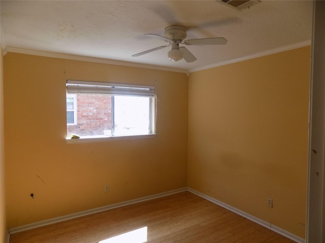 unfurnished room with light wood-style flooring, a ceiling fan, baseboards, and ornamental molding