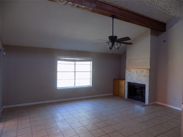 unfurnished living room featuring light tile patterned floors, baseboards, lofted ceiling with beams, a fireplace, and ceiling fan