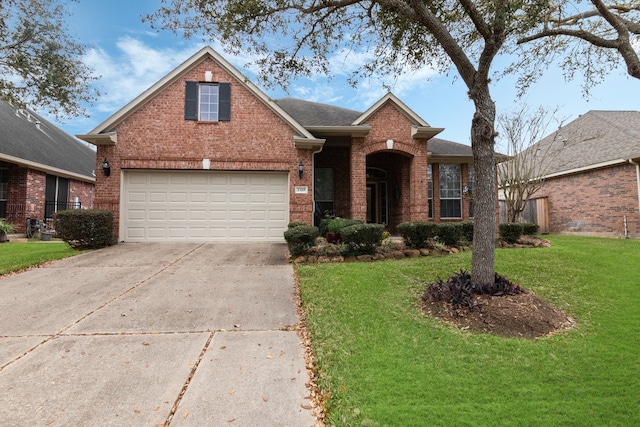 traditional home featuring brick siding, concrete driveway, a front yard, roof with shingles, and a garage