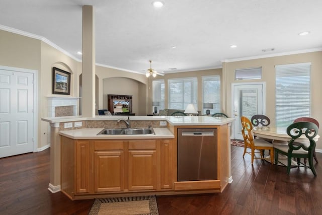 kitchen featuring open floor plan, dishwasher, light countertops, and a sink